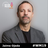 Retrato de Jaime Ojeda, presentador del podcast World Media, con fondo gris. El diseño incluye el logotipo del podcast y el hashtag #WM19.